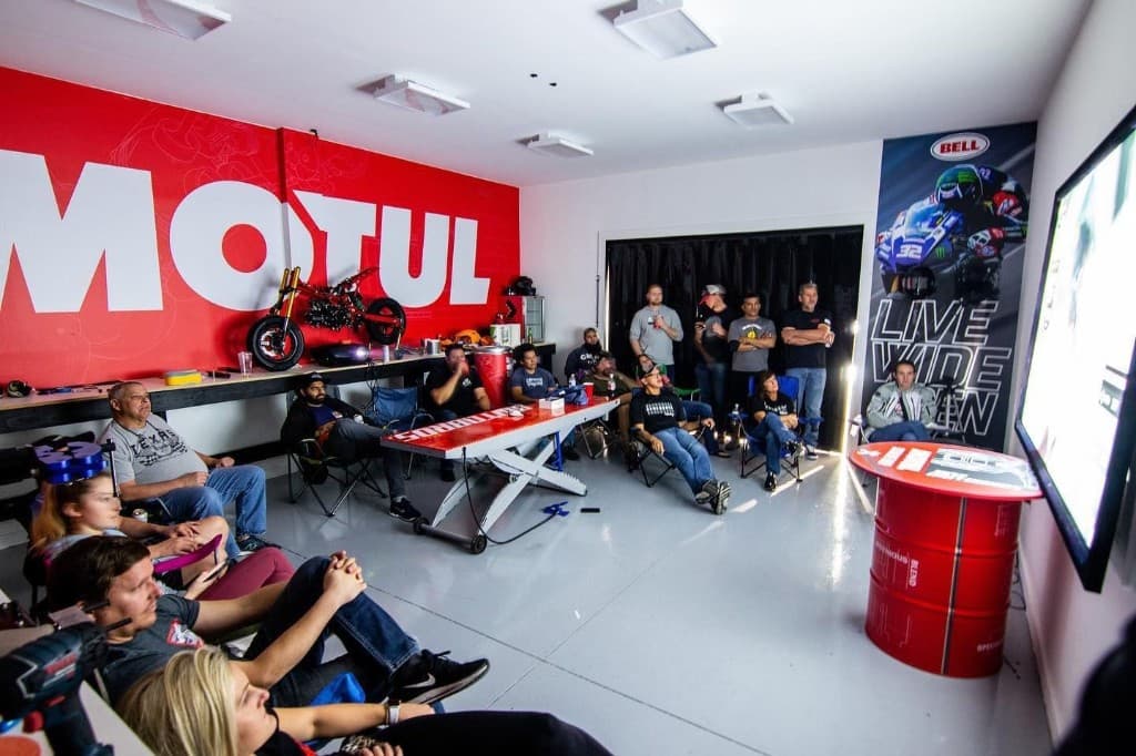 MotoBros members gathered in the shop for a watch party