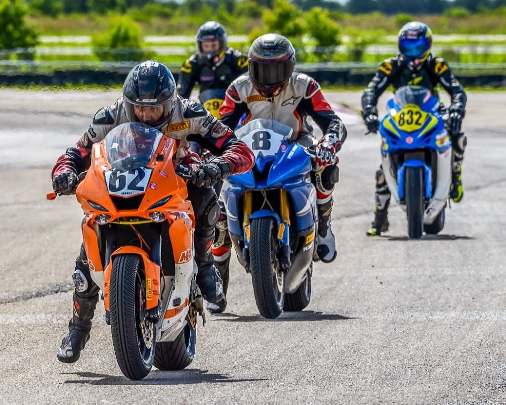 MotoBros riders racing sportbikes on track