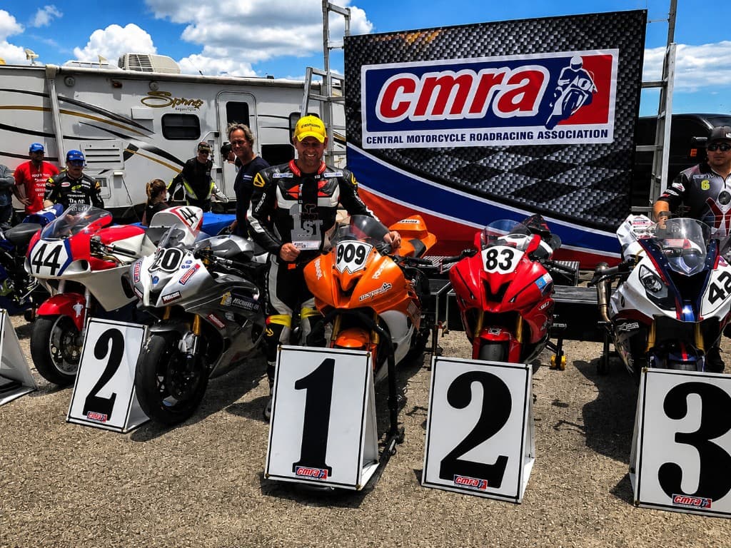 MotoBros rider celebrating a podium finish after performance tuning