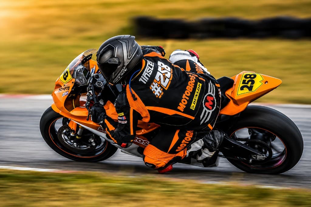 MotoBros rider cornering hard on track after tuning validation