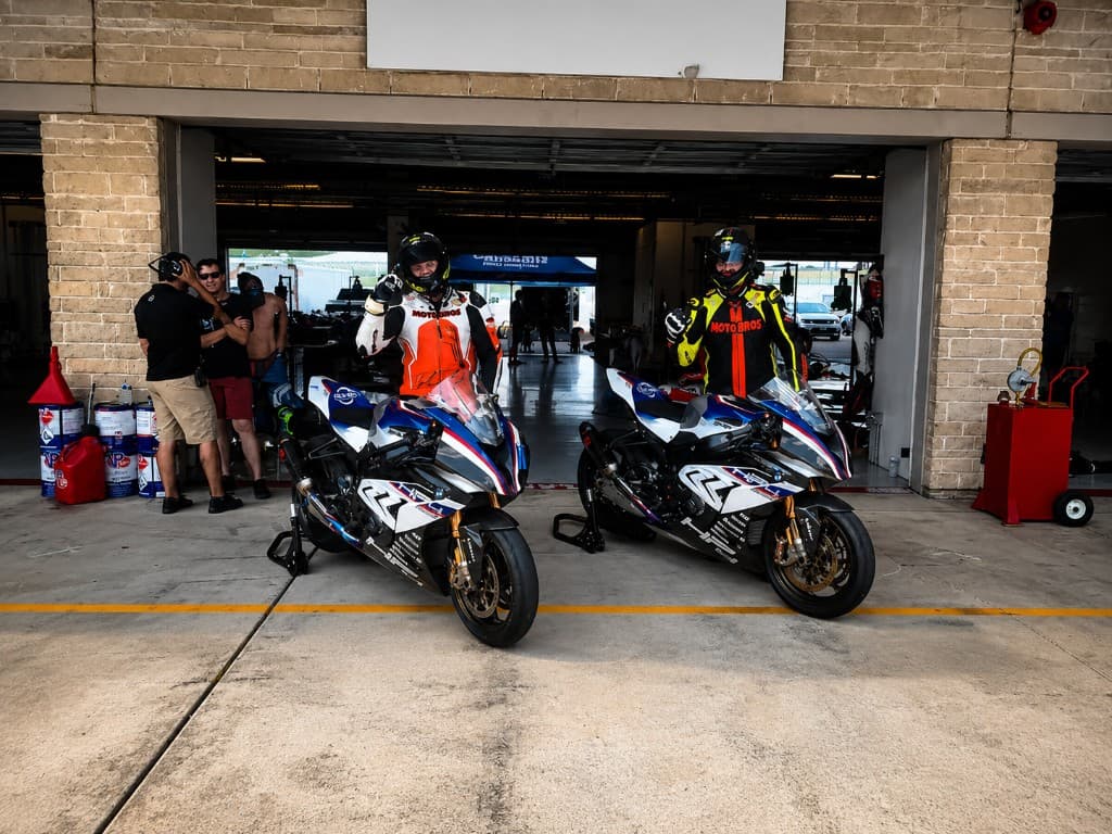 MotoBros team with race bikes in the paddock garage