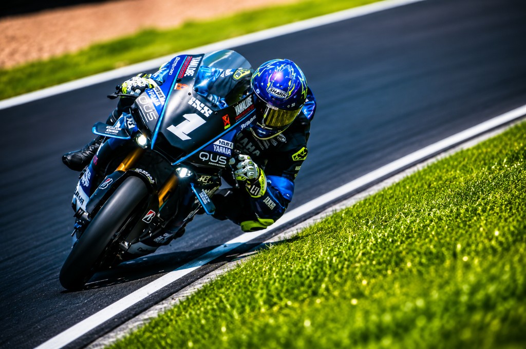 Yamaha sportbike leaning into a turn on a racetrack